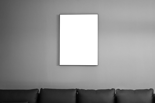 An empty picture frame on the sofa in the living room