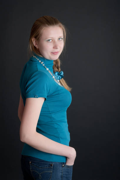 girl in a blue blouse on black background