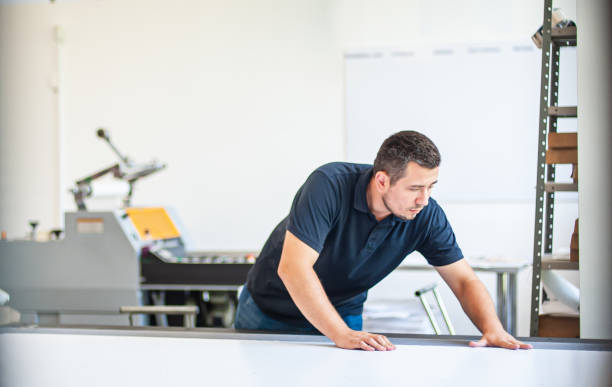 istock Professional worker printmaker technician operator works in modern printing plant 1443885259