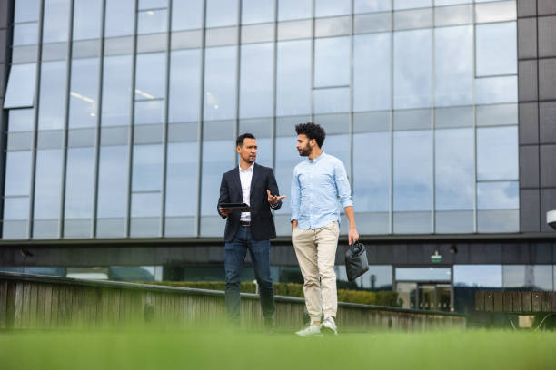 istock Two Busienss People Walking While Having A Meeting On The Move 1443886942