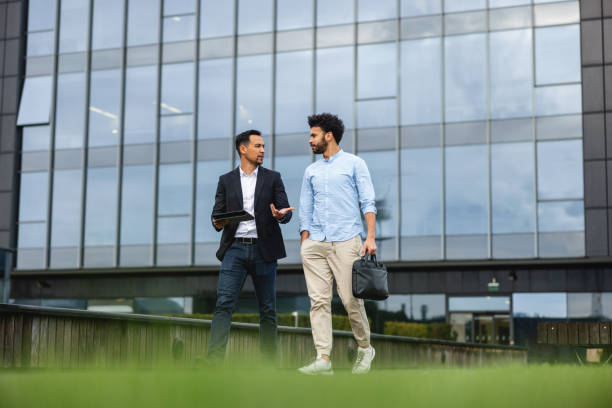 istock Two Busienss People Walking While Having A Meeting On The Move 1443886944