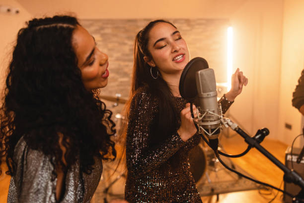 istock Two Female Singers Passionately Singing In A Music Studio 1443887106