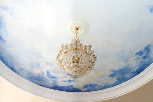 crystal chandelier on white and blue ceiling - copy space