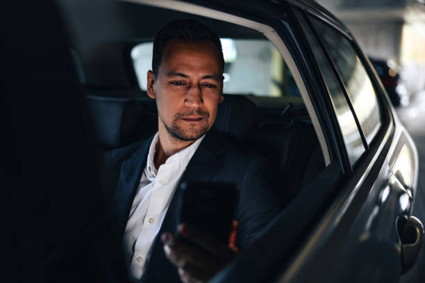 istock Focused Businessman Being Driven In A Taxi While Using A Smart Phone 1443887460