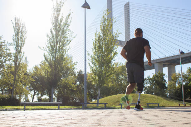 istock Back view of man with disability training in city park 1443890049