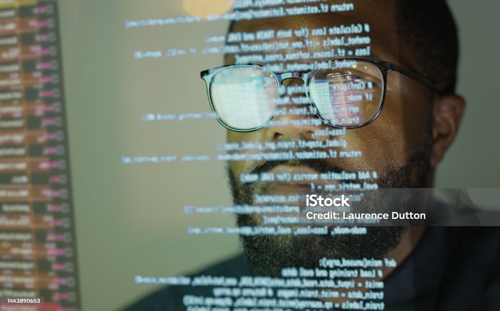 Coding see through Stock photograph of an afro Caribbean (afro American) man studying a see through display depicting Python computer coding. Coding Stock Photo