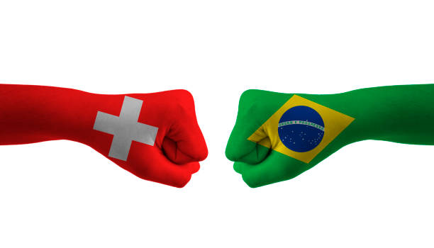 istock Brazil VS switzerland hand flag Man hands patterned football 1443891577