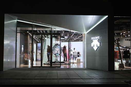Beijing,China-September 14th 2022: facade of Descente retail store at night.  A Japanese sports clothing company