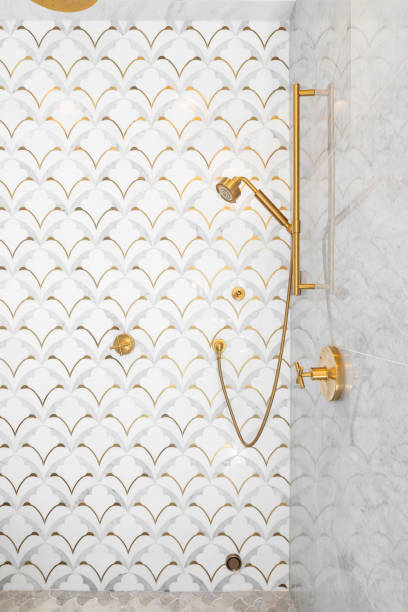 istock A shower with a mosaic tile and gold faucet. 1443896352