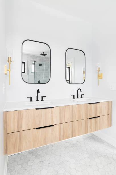 istock A bathroom with a wood vanity and black mirrors. 1443896427