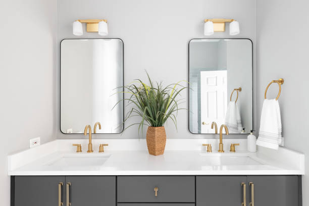 istock A bathroom with a grey cabinet and gold faucets. 1443896614