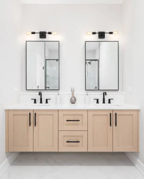 Photo of A modern bathroom with a wood floating vanity.