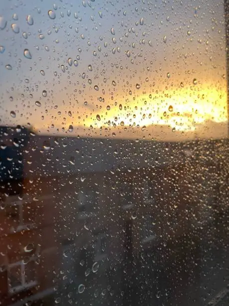 Raindrops on the window during golden hour