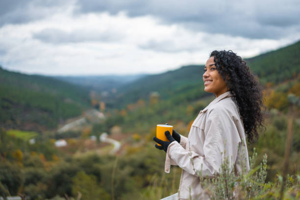 istock Afro woman drinking hot coffee on excursion in the mountains 1443903307