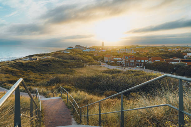 View over the beaches of Walcheren in Zeeland near Domburg in the early morning at sunset Coastline with a view over the dunes and the seaside resort of Domburg at sunset, Province Zeeland, Netherlands north sea waves stock pictures, royalty-free photos & images