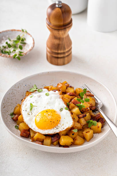 istock Potato, onion and ham hash topped with fried egg 1443907961