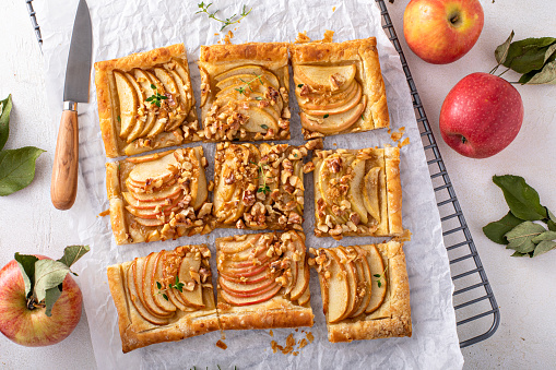 Apple tart with puff pastry tpped with sliced apples, walnuts and brown sugar caramel sliced into squares