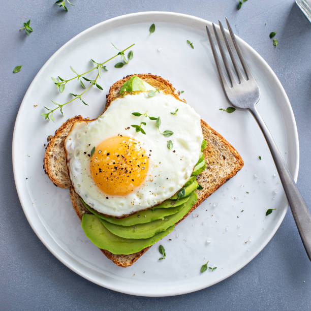 istock Avocado toast on a toasted multigrain bread with a fried egg 1443907993
