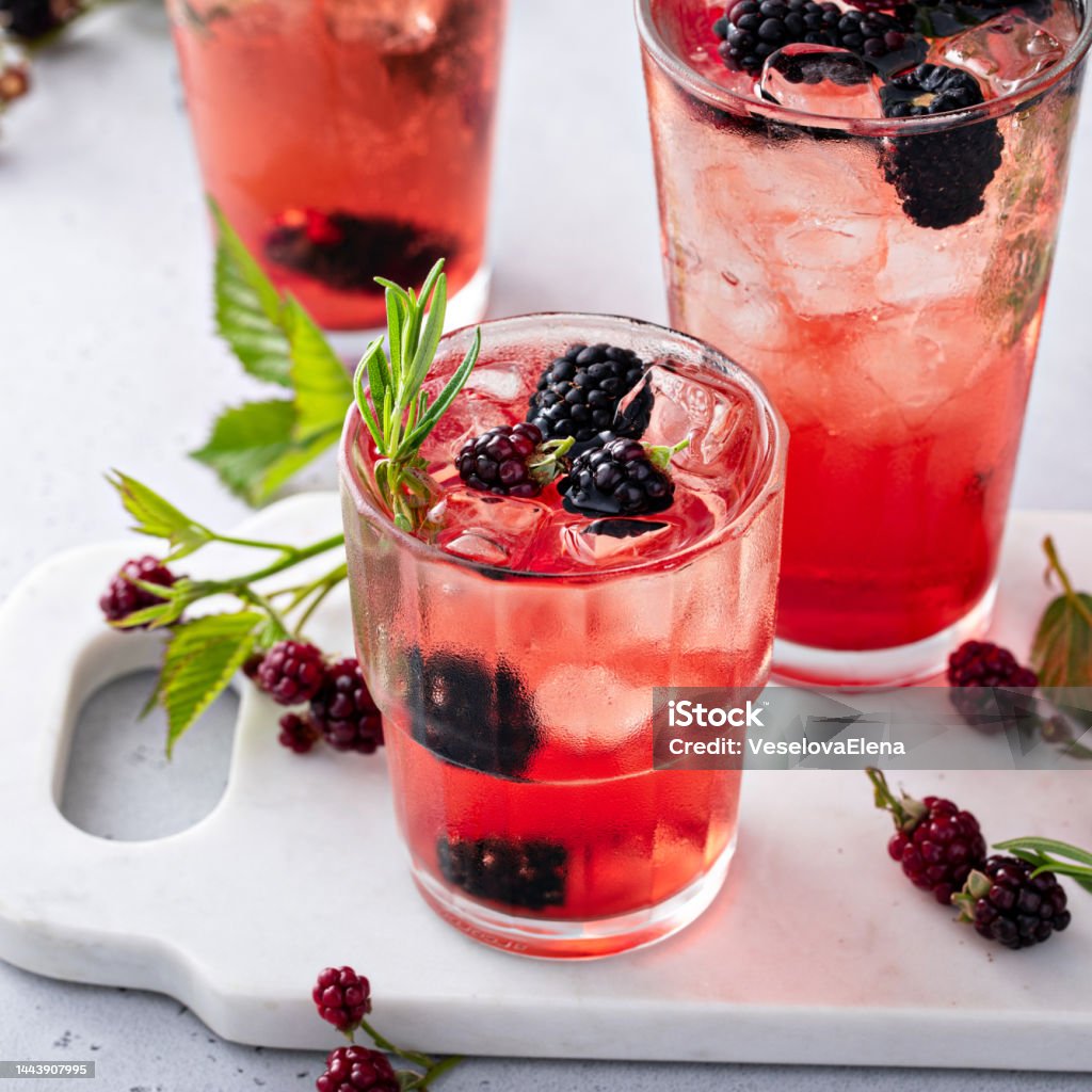 Refreshing blackberry cocktail with fresh sprig of rosemary Refreshing blackberry cocktail or mocktail with fresh rosemary, cool summer or fall drink Alcohol - Drink Stock Photo
