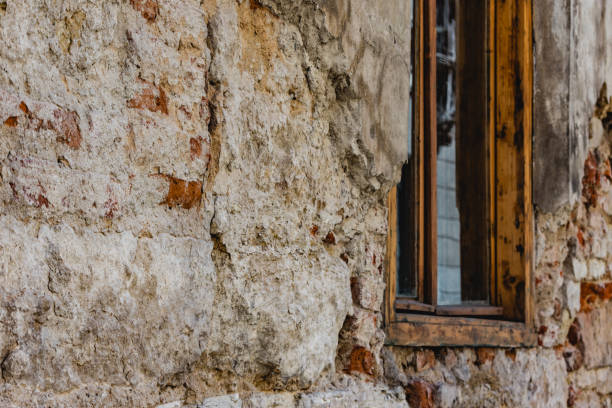 Home or shelter for poor people that stepped into poverty with rugged walls and a wooden window. Shot in perspective