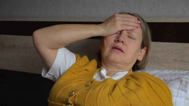 istock Depressed mature female puts hand on forehead feeling bad 1443912832
