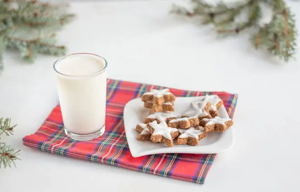 Delicious fresh milk on an old wooden background. A jug of milk and a bottle of milk. Christmas. For Santa. Copy space