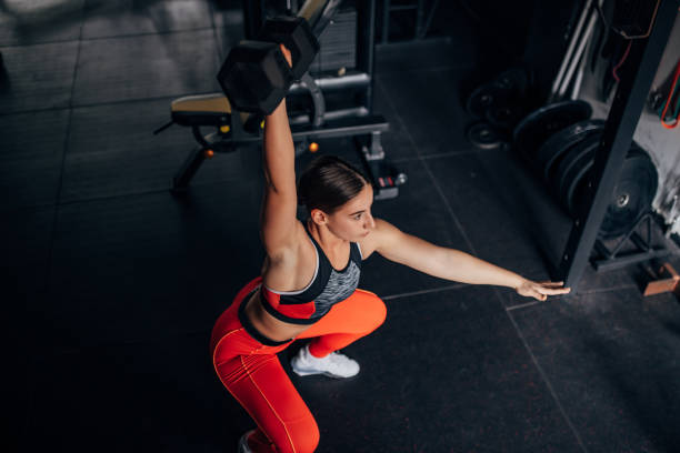 istock Fit woman training with dumbbell 1443914912