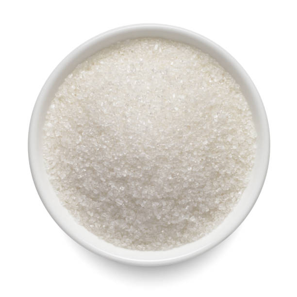 istock Crystal sugar in round bowl isolated on white. Top view. 1443915551
