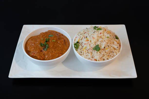 istock Paris, France - 04 25 2021: Indian dishe culinary Still Life. Chicken Madras served with rice on a plate 1443917621