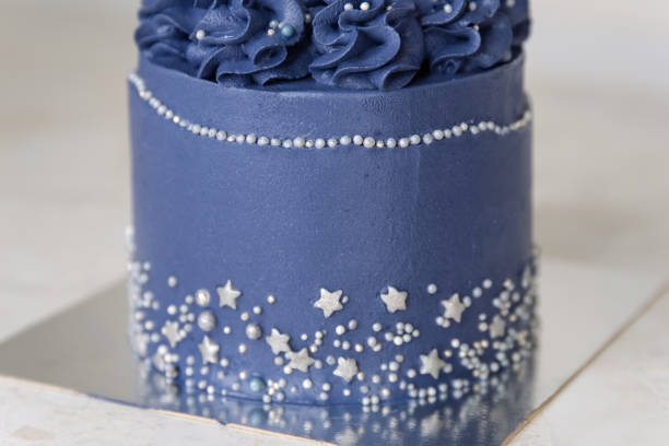 istock Appetizing fresh pastry cake covered by blue cream icing 1443926051