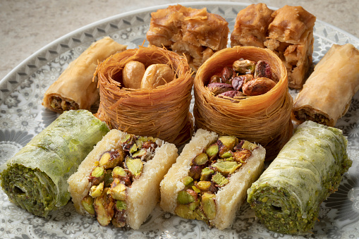 Dish with traditional Syrian cookies stuffed with cashew and  pistachio nuts close up