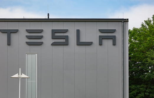 Neuwied, Germany - June 20, 2021: the lettering of the car manufacturer TESLA on the exterior of a production hall - copy space