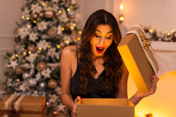 istock Portrait of a Surprising woman while opening a gift box. 1443927407