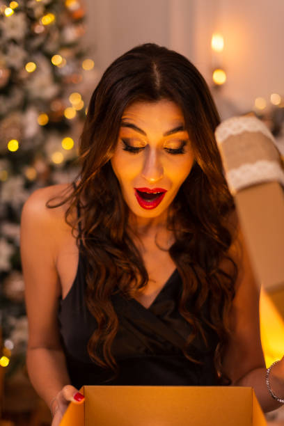 istock Portrait of a Surprising woman while opening a gift box. 1443927425