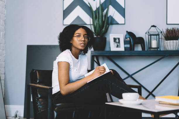 istock Teenager girl doing homework assignment while sitting at chair 1443930406
