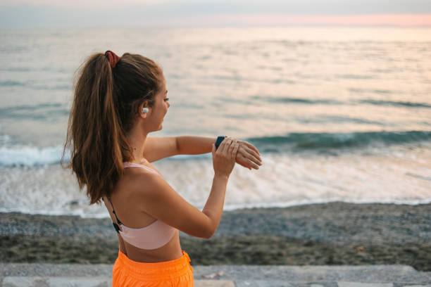 istock Checking progress on a smart watch after running by the sea 1443937209