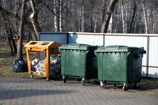 istock Three large trash cans in the park. One of them is for plastic. Separate garbage collection 1443937858