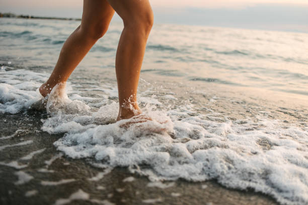 istock Running barefoot by the sea 1443937932