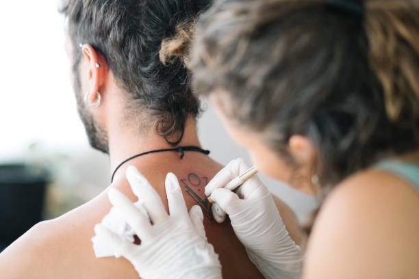 istock Handpoke tattoo technique minimalist design 1443939017