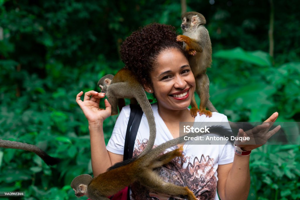 people traveling travel people in the amazon with monkeys enjoying nature. Amazon Rainforest Stock Photo