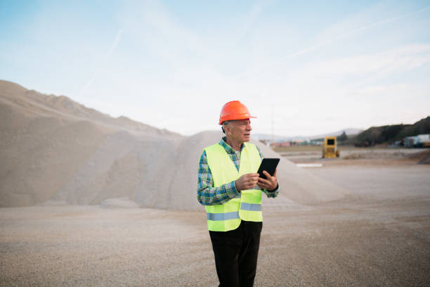 istock Senior adult man using a digital tablet computer on a construction yard 1443941365