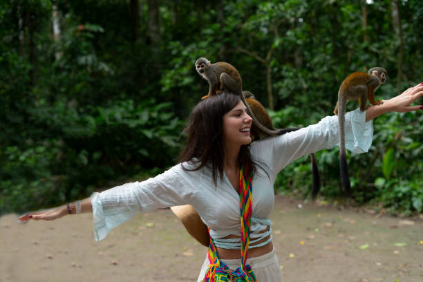 people traveling travel people in the amazon with monkeys enjoying nature. colombian ethnicity stock pictures, royalty-free photos & images