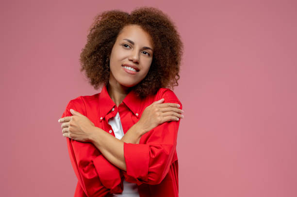 istock Pretty curly-haired woman in red jacket looking romantic 1443945625