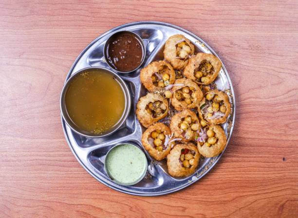 pani puri or gol gappay with raita, sweet sauce and spicy water served in dish isolated on table top view of indian and pakistani food pani puri or gol gappay with raita, sweet sauce and spicy water served in dish isolated on table top view of indian and pakistani food panipuri stock pictures, royalty-free photos & images