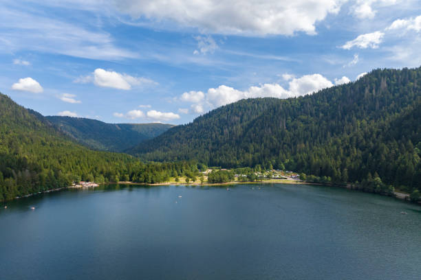 Longemer lake in the French Vosges region at Xonrupt-Longemer during a beautiful summer day. Panoramic drone view from above.
