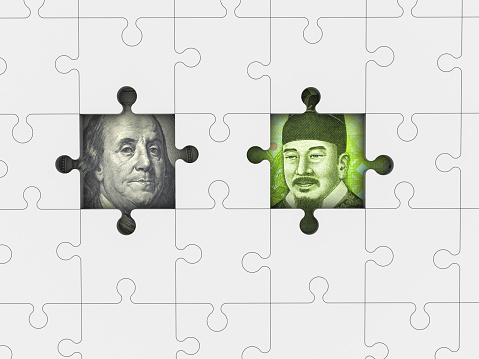 Dollar and Korean Won with jigsaw puzzle