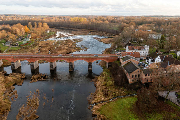 istock Venta Rapid waterfall, the widest waterfall in Europe and long brick bridge 1443947699