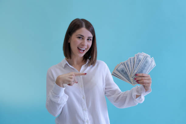 istock Woman holds stack of money 1443947960