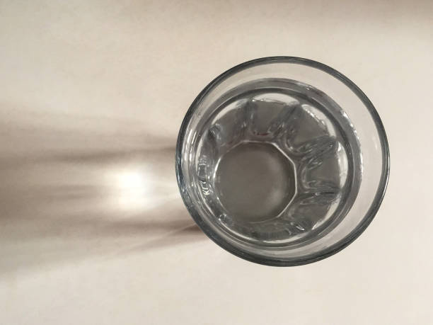 istock Glass of water on the white background with reflections 1443948281