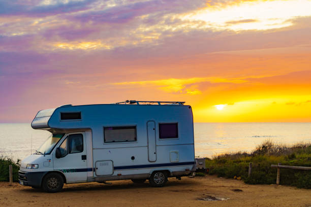 istock Camper vehicle camp on beach at sunrise 1443951899